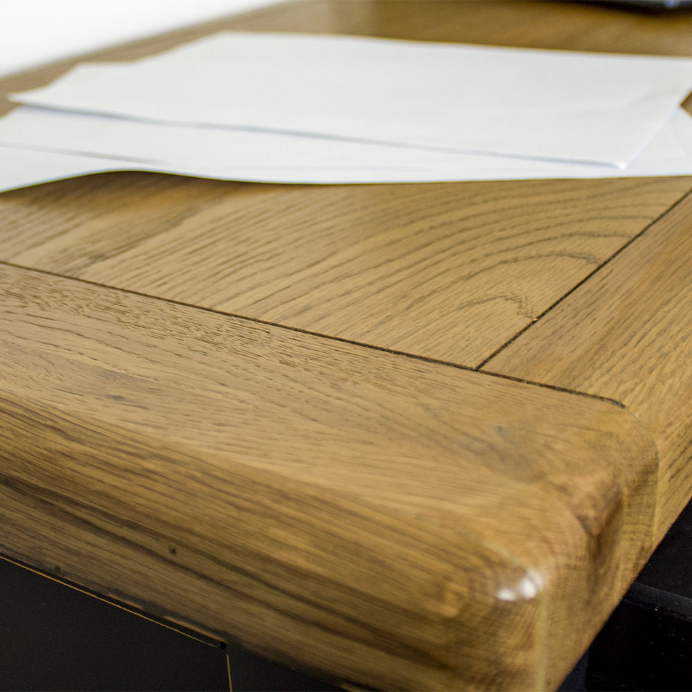 A close up of the top of the Cascais Black Desk, showing the wood grain and colour.